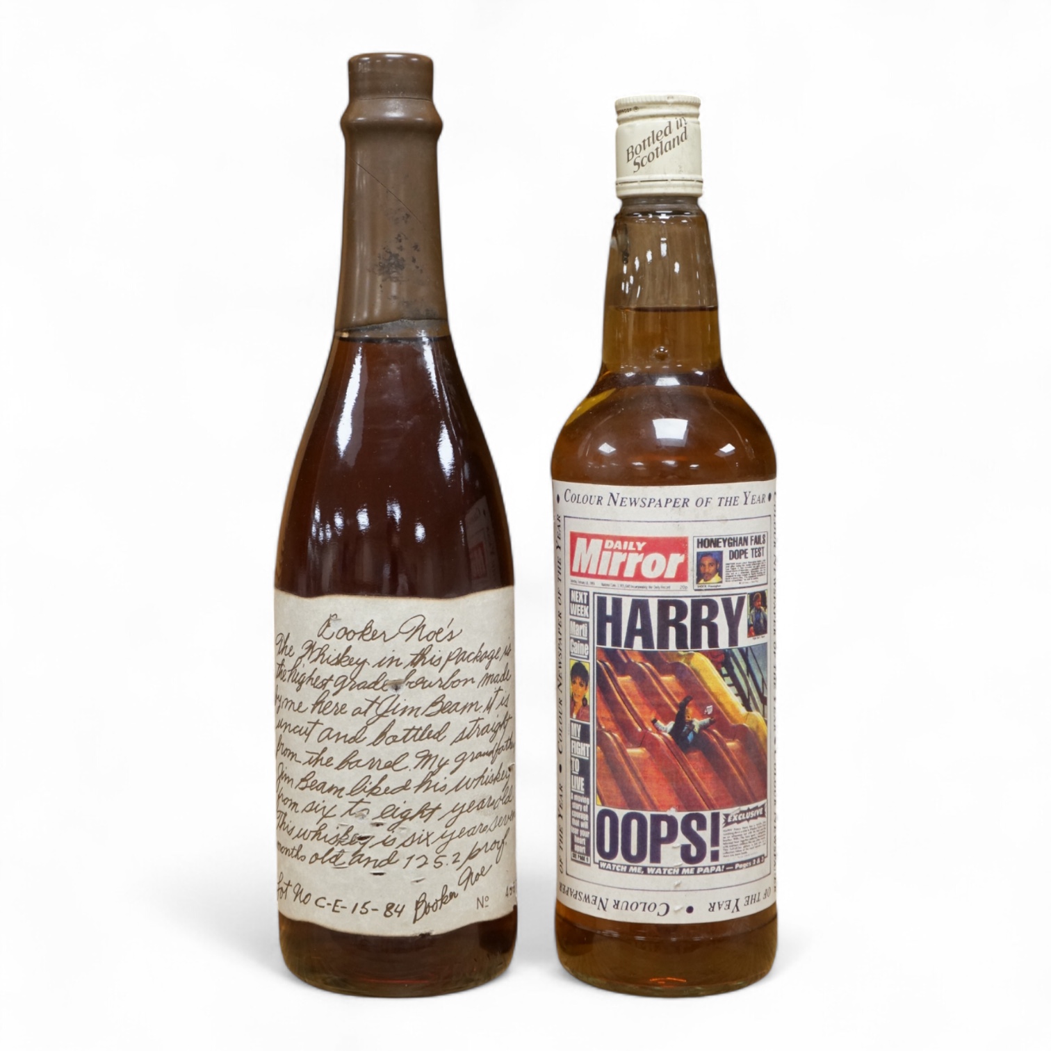 A bottle of ‘Daily Mirror’ Famous Grouse whisky and a bottle of Booker Noe’s Kentucky Bourbon Whiskey, bottled by James B. Beam Distilling Co.